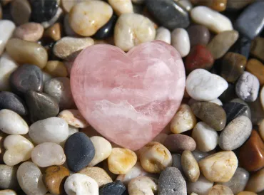 a pebble rock garden with a rose quartz heart
