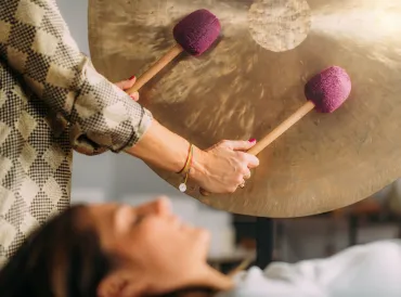 a woman receiving sound therapy