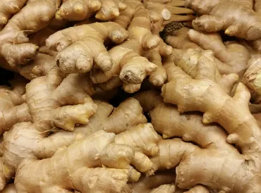 a platter of sliced and whole ginger root