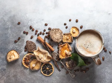 dried mushrooms, coffee beans, and a steaming cup