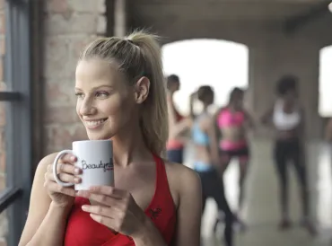 A woman drinking tea in the yoga studio