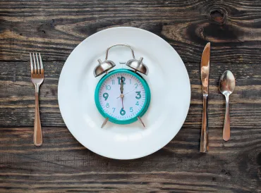 a clock on a dinner plate