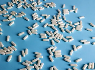 White capsules on a light blue background. 