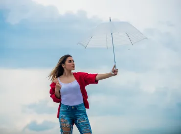 Woman holding up white umbrella