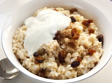 a bowl of rice porridge with nuts and fruit