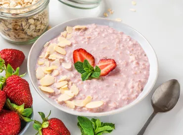 a bowl of strawberry oatmeal with almonds