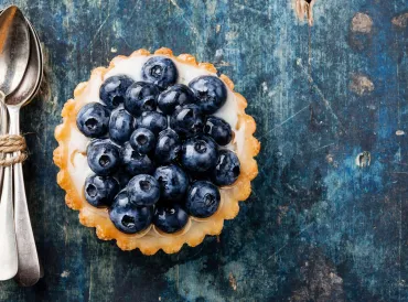 Blueberry tart and spoons
