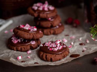 a plate of chocolate cookies with crushed candy canes