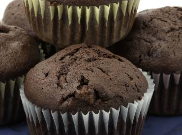 A plate of chocolate cupcakes in paper cups