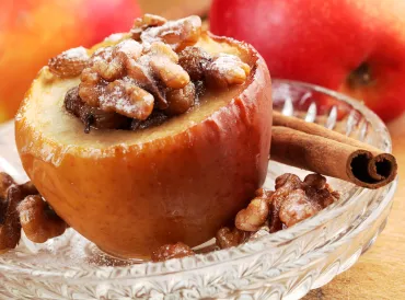 a baked apple stuffed with walnuts and raisins