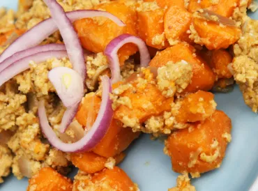 A plate of sweet potato scramble with red onion on top