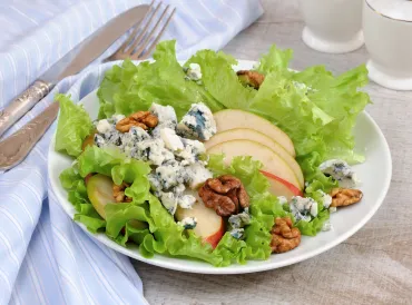 a green salad with pears, gorgonzola, and nuts