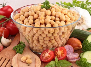 A bowl of chickpeas and salad ingredients
