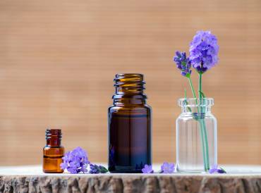 Lavender essential oil bottles and fresh flowers for aromatherapy.