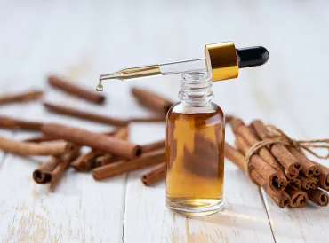 cinnamon bark and a bottle of oil