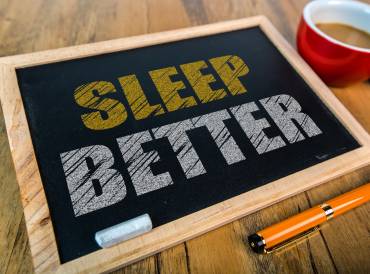 Small chalkboard with the message Sleep Better written in chalk on it.