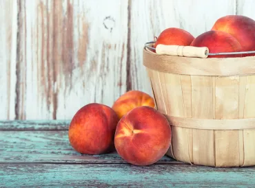 A basket of fresh organic peaches.